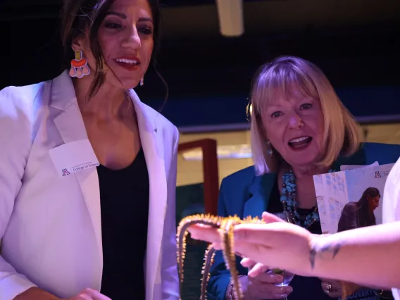 Two woman learn about marine life at Flandrau's Undersea Discovery exhibit in Tucson