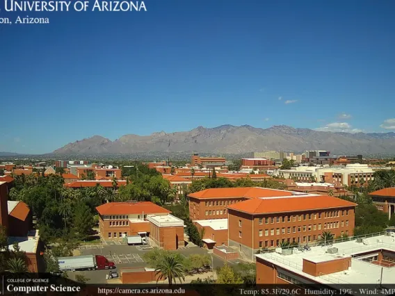 Screenshot from a UArizona Dept of Computer Science webcam video show campus with the mountains in the background. 