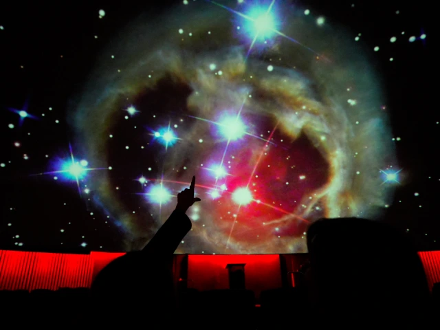 People pointing at the planetarium stars in the dome.