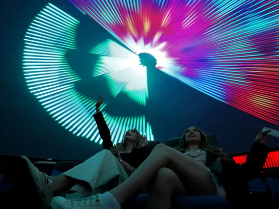 two young women in flandrau planetarium at a laser show