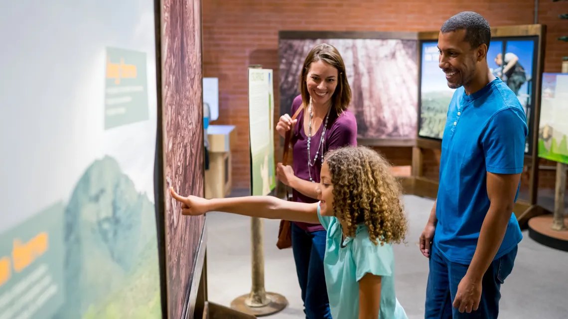 family visiting science exhibits