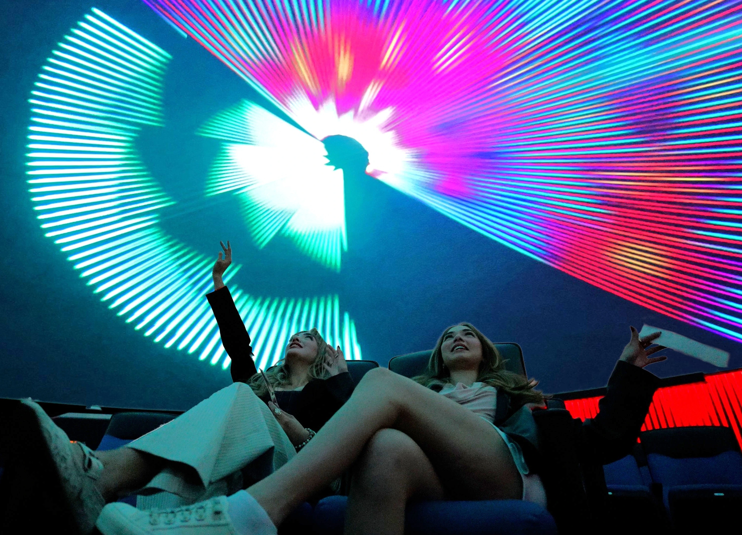 two young women in flandrau planetarium at a laser show