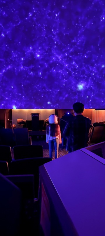 Little girl in purple planetarium dome