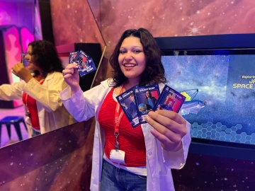 Galaxy Slam trading cards held by Flandrau staff