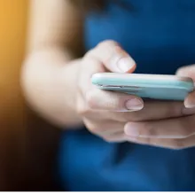 Adult holding phone with two hands