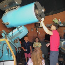 Summer campers look at telescope